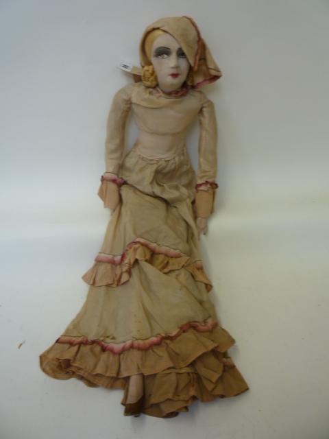 Dolls & Equipment. A 1920`s boudoir doll with moulded fabric painted face, stuffed body, composition