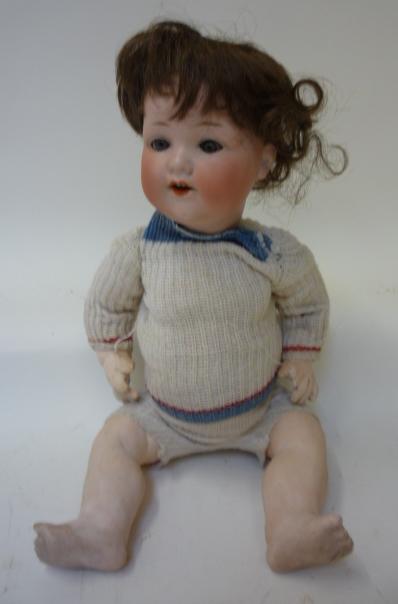 Dolls & Equipment. An Armand Marseille bisque head character boy doll with blue glass sleeping eyes,