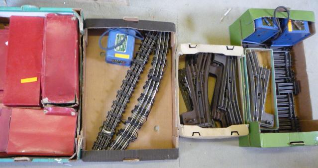 Model Railways. A quantity of Hornby three rail and clockwork tinplate track including eleven pieces