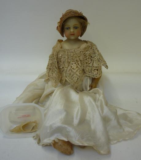 Dolls & Equipment. A wax shoulder head doll with fixed blue glass eyes, imbedded blonde mohair
