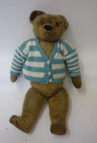 Teddies & Soft Toys. A Chad Valley early 20th century teddy bear, straw filled, covered in worn gold