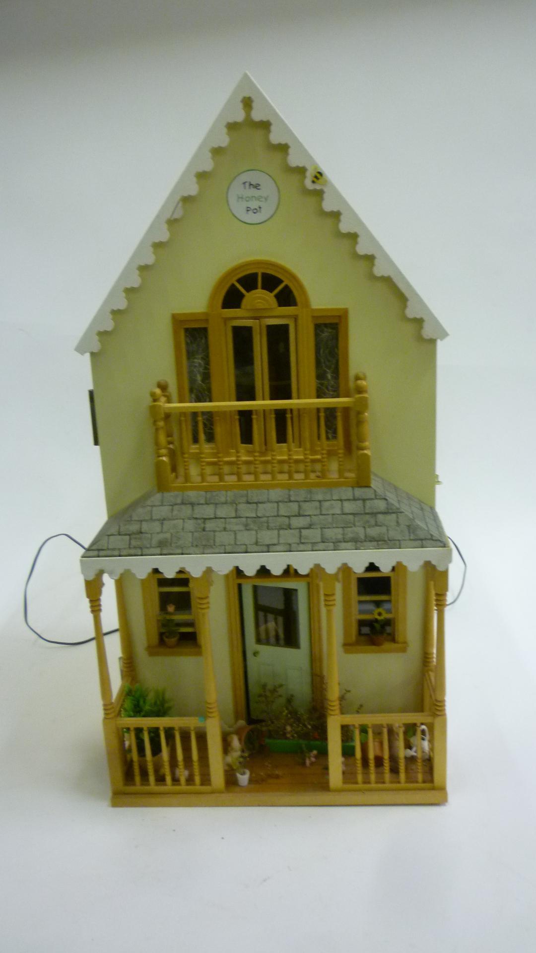 Dolls & Equipment. A kit built doll`s house, wood and painted construction, with shallow pitched