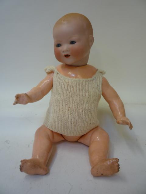 Dolls & Equipment. An Armand Marseille bisque head baby doll with blue glass sleeping eyes, open