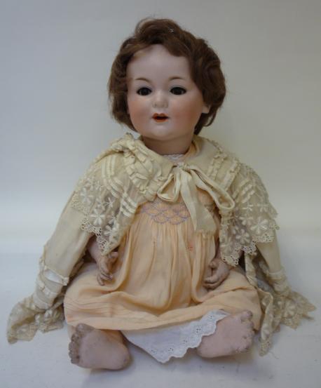 Dolls & Equipment. A George Borgfeldt bisque head girl character doll with brown glass sleeping