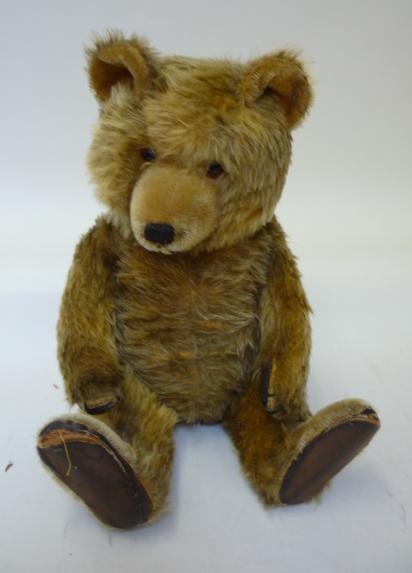 Teddies & Soft Toys. An English musical teddy bear, c.1950, covered in dark gold plush with swivel