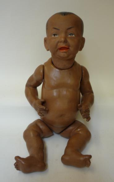 Dolls & Equipment. A Kammer & Reinhardt bisque head black baby character doll with painted face,