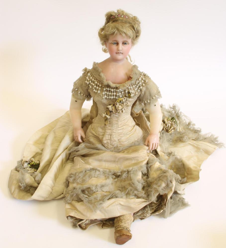 Dolls & Equipment. A French wax fashion doll with shoulder head, blue glass eyes, coiffed blonde