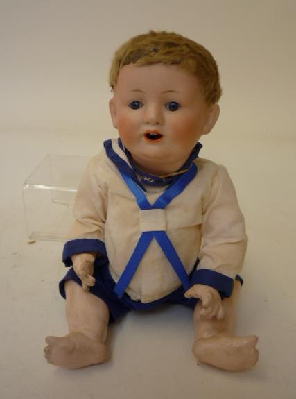 Dolls & Equipment. A Franz Schmidt & Co bisque head boy doll with blue glass sleeping eyes, open