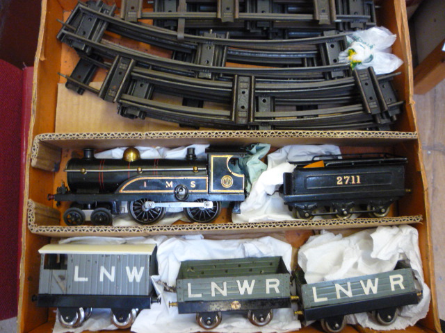 Model Railways. Hornby clockwork No 2 4-4-0 L.M.S. locomotive and tender finished in black with 2711
