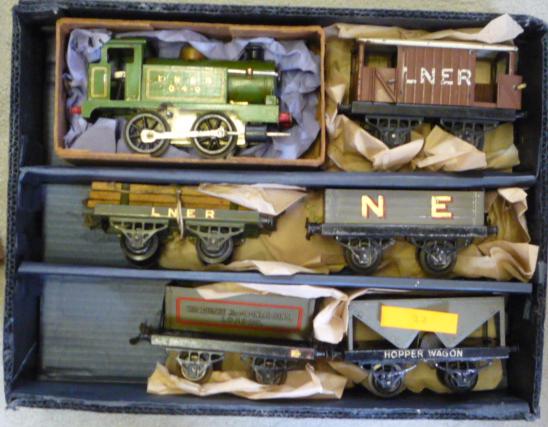 Model Railways. Hornby clockwork L.N.E.R. No.1 tank locomotive, four N.E. goods trucks, and an L.N.