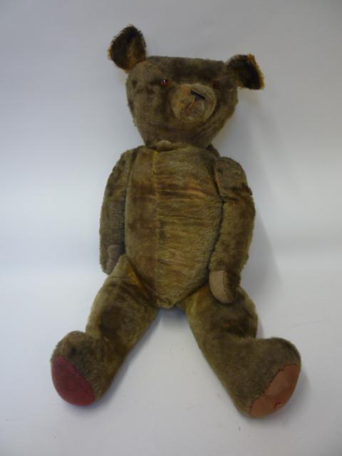 Teddies & Soft Toys. A large English teddy bear, early to mid 20th century, straw filled, covered in