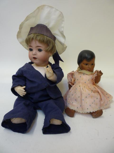 Dolls & Equipment. A Franz Schmidt & Co bisque head sailor doll with blue glass flirty eyes, open