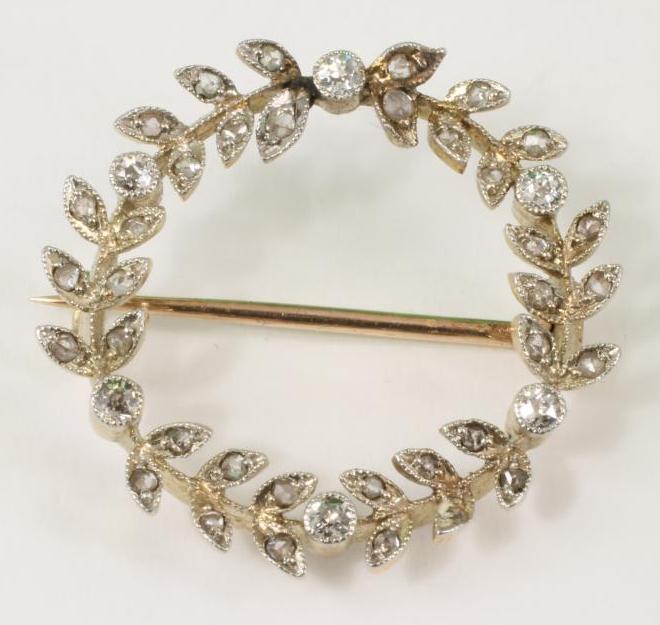 A LATE VICTORIAN DIAMOND CIRCLET BROOCH, each three pairs of leaves millegrain set with rosecut