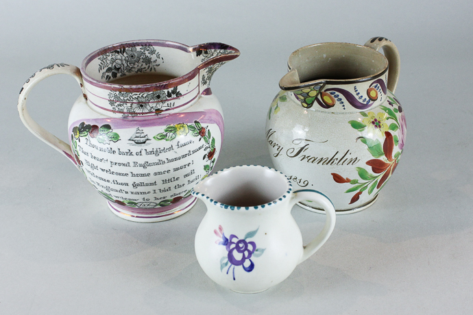 A 19th century Sunderland pink lustre jug with view of the iron bridge and verse, 12cm, another with