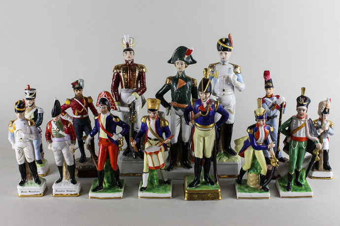 A collection of fourteen soldier figurines to include five figurines made in Western Germany,