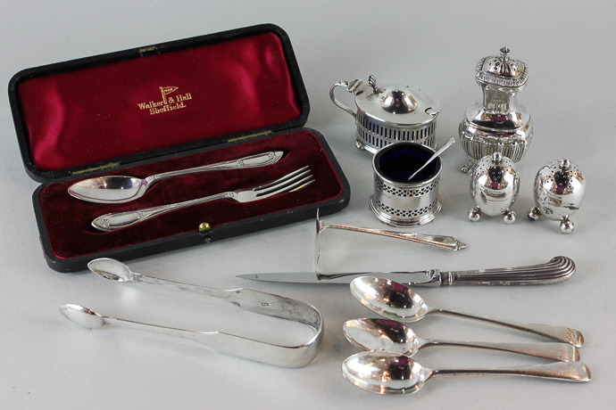 A pair of George V silver pepper pots, three other cruets, cased christening spoon and fork, three