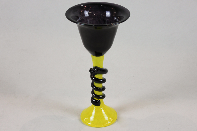 A 20th century Swedish glass chalice with amethyst coloured bowl on yellow stem and base, with
