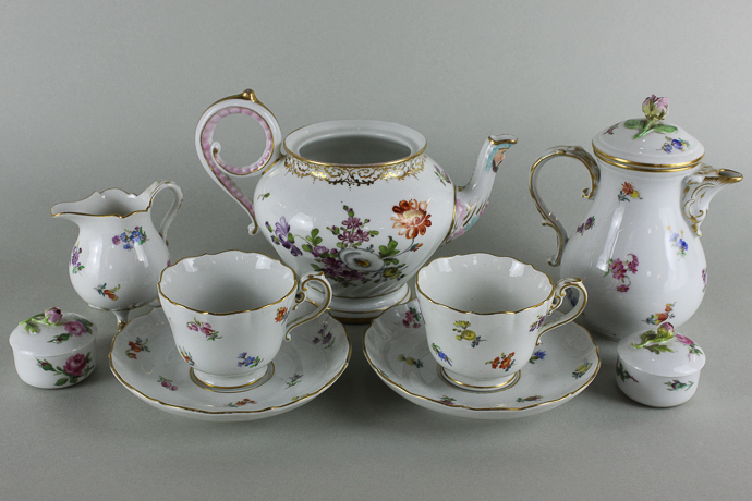 A Meissen porcelain coffee set for two comprising coffee pot, cream jug and two cups with saucers