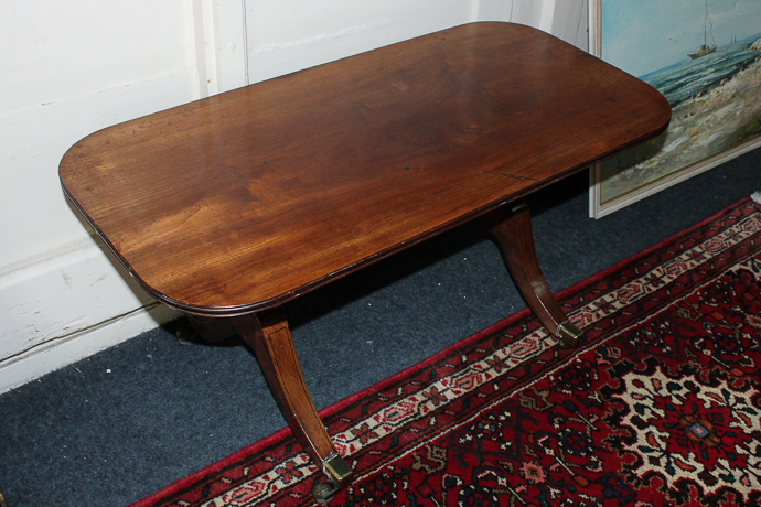 A mahogany coffee table on twin trestle supports, 92cm by 45cm