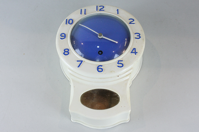 A painted blue and white metal cased `kitchen` clock, 25cm high