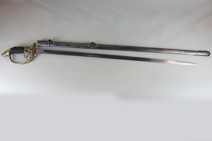 A 19th century Prussian sword with 78.5cm blade, pierced eagle folding guard, in metal scabbard,