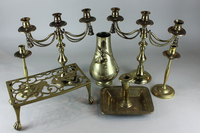A brass trivet, a brass chamber candlestick, a pair of brass candlesticks and other brassware