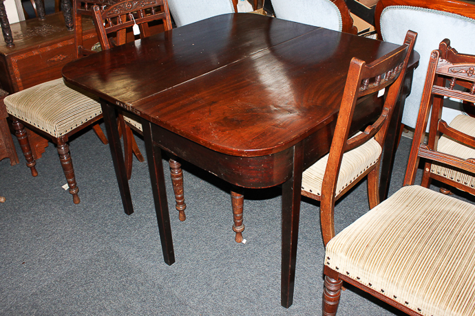 A 19th century mahogany tea table with D shaped folding top on six square tapered legs, 108cm