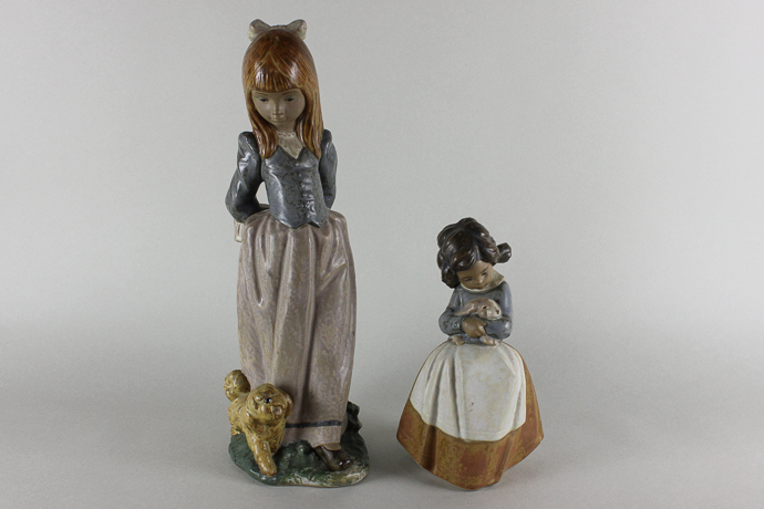 A Lladro ornament of a young girl in long dress with a dog at her feet, 36cm high, together with a