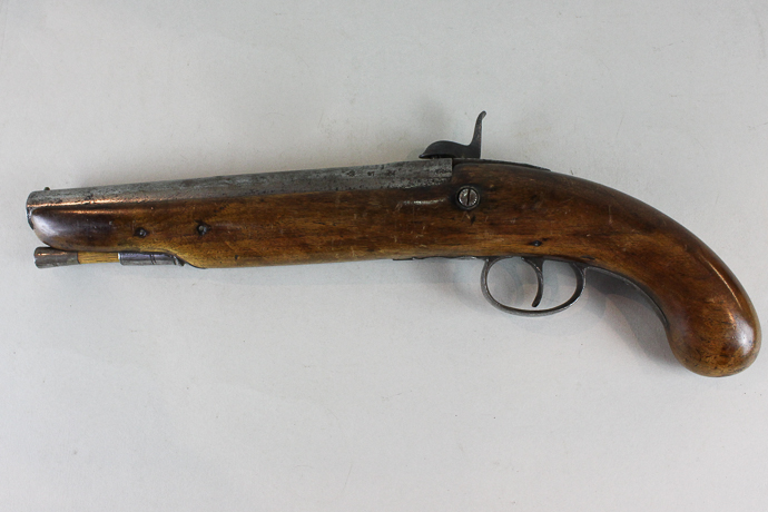 A 19th century percussion pistol with engraved lock plate and hammer, plain walnut stock, 38cm