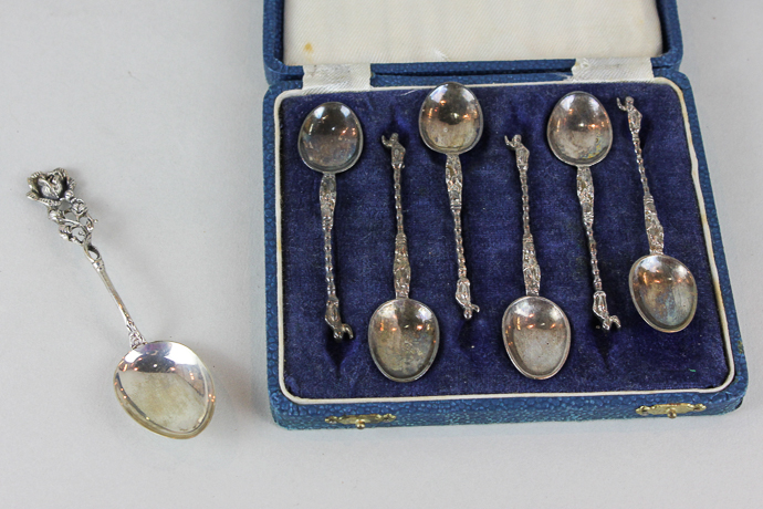 A set of six Continental silver coffee spoons with Apostle handles in case, and one rose handled