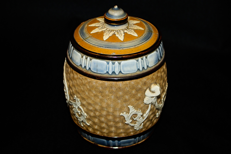 A Doulton Lambeth stoneware pot with scroll decoration (cover repaired)
