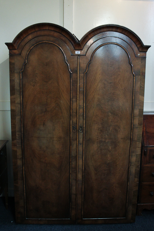 A Queen Anne style walnut double dome top wardrobe, lacks base section, 119cm