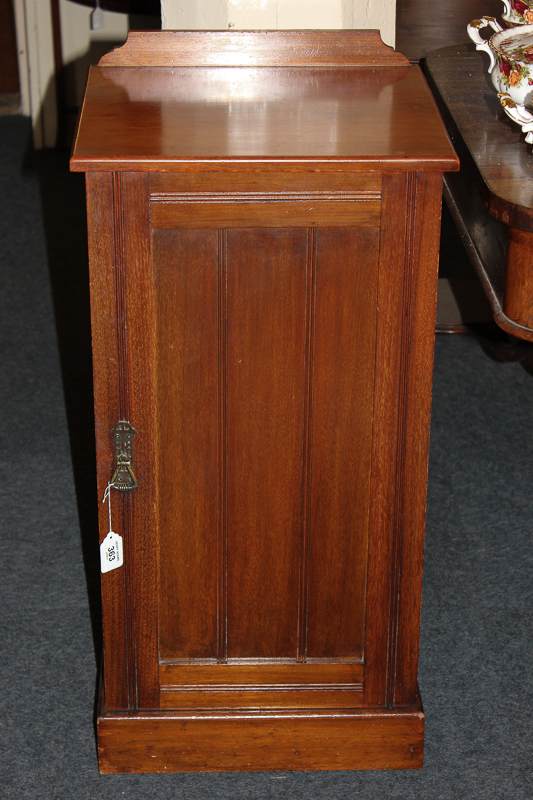 An early 20th century mahogany bedside cupboard enclosed by one door, 40cm