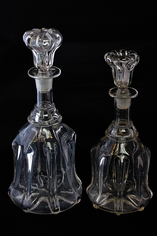 Four similar bell shaped glass decanters with stoppers