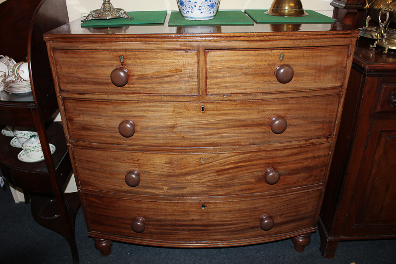A 19th century mahogany bow front chest of two short and three long drawers, on turned feet, 106cm