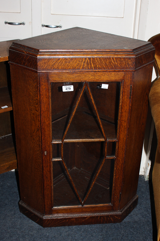 An oak panel glazed corner hanging wall cabinet, 55cm, a small bookcase, 38cm, and a standard lamp