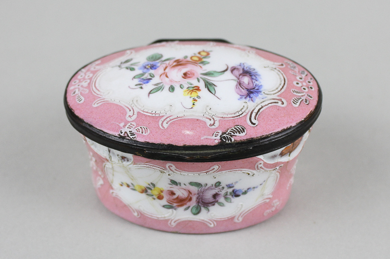 A 19th century pink enamel oval box with floral panel decoration (a/f)