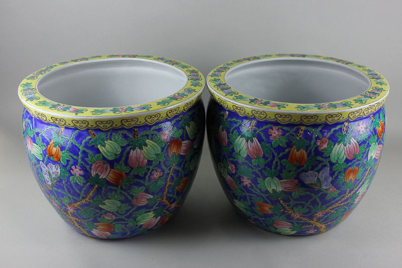 A pair of 20th century circular `Chinese` porcelain jardinières, both richly decorated in bright