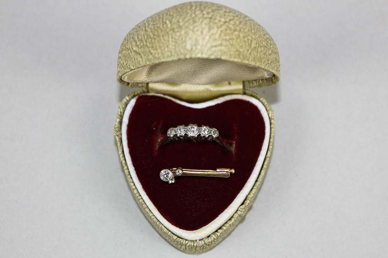 An 18ct gold and diamond five stone ring and a small diamond set pin
