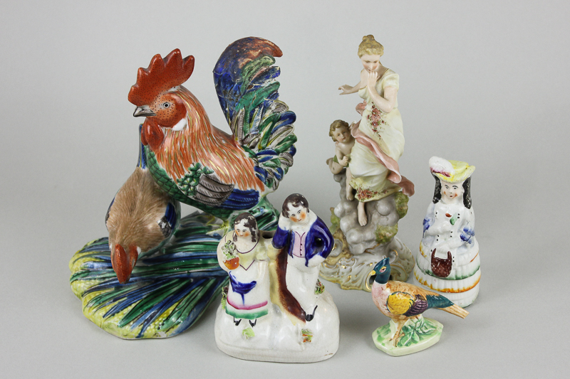 A pottery figure group of a cockerel and hen, two small Staffordshire figures, a porcelain figure of