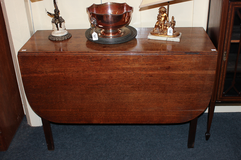 An oak drop-leaf dining table on square legs, extends to 132cm