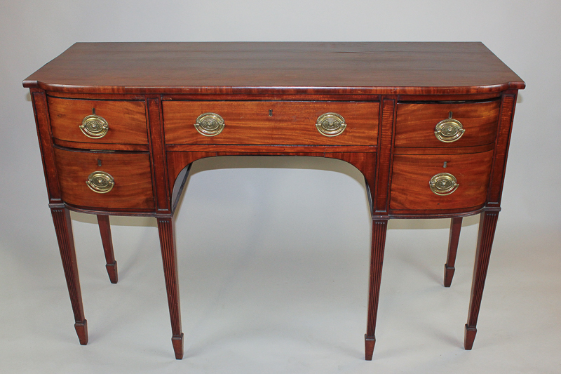 A 19th century mahogany bow front sideboard with one centre drawer flanked by one deep and two short