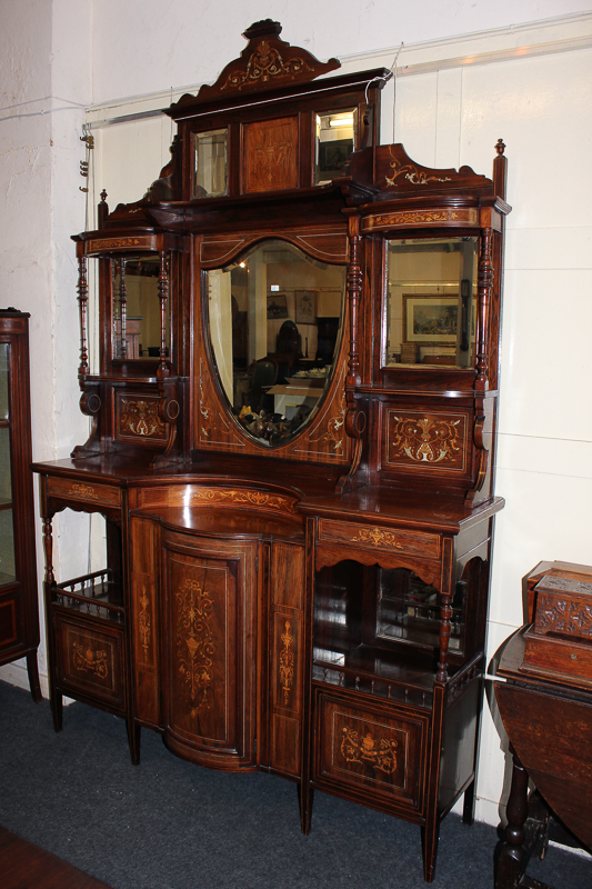 A late Victorian rosewood and marquetry decorated cabinet with shield shaped mirror and open shelf