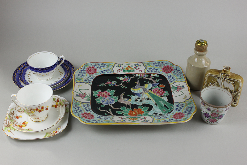 A Japanese porcelain dish decorated in bright enamel colours, together with two part tea sets,