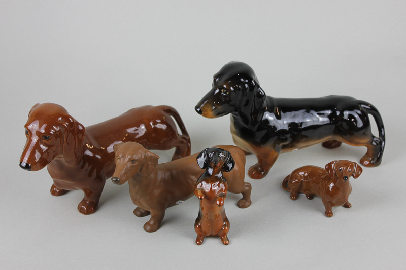 Two Beswick Dachshunds standing 361, one in black/tan, one in tan gloss, a begging Dachshund 1461 in