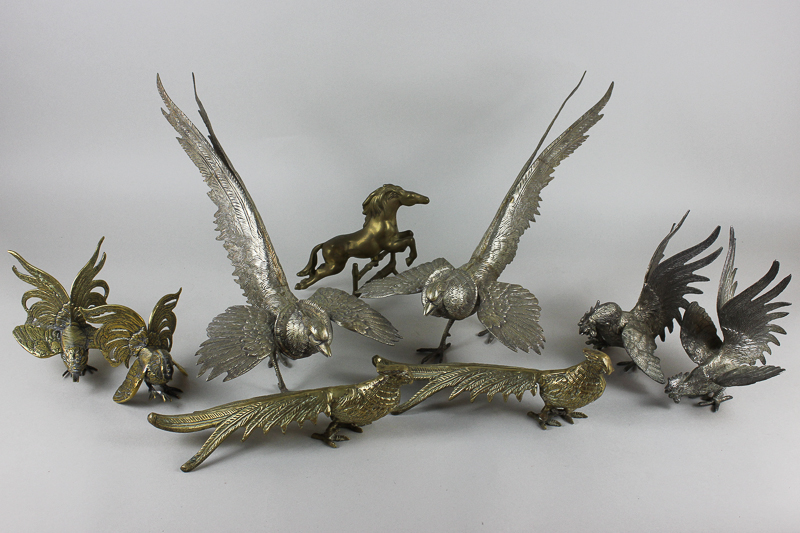 A pair of silverized pheasant ornaments, a smaller pair of fighting cockerels, a pair of brass