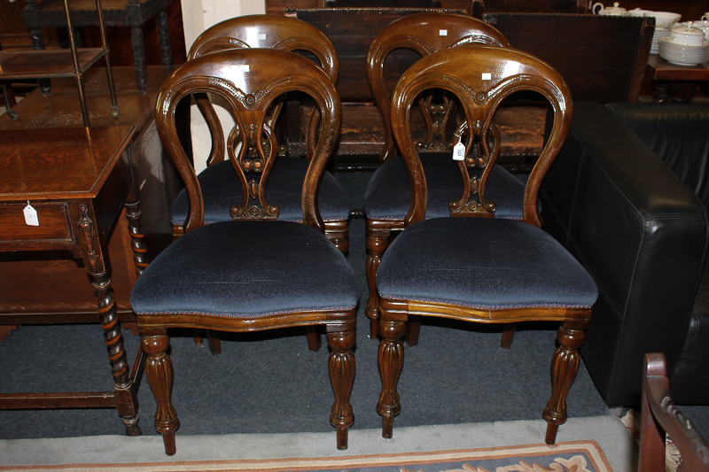 A set of four Victorian style dining chairs with fretted back splats and upholstered seats