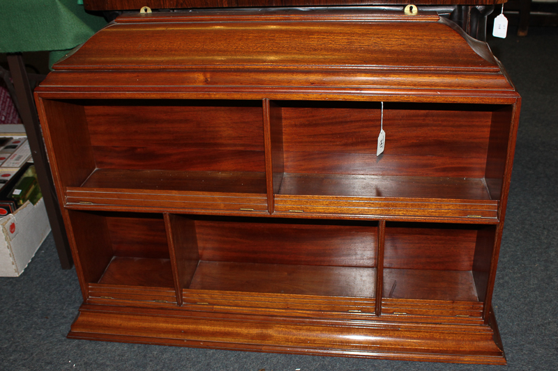 A mahogany wall shelf with fold-down fronts, moulded surmount and plinth base, 96cm