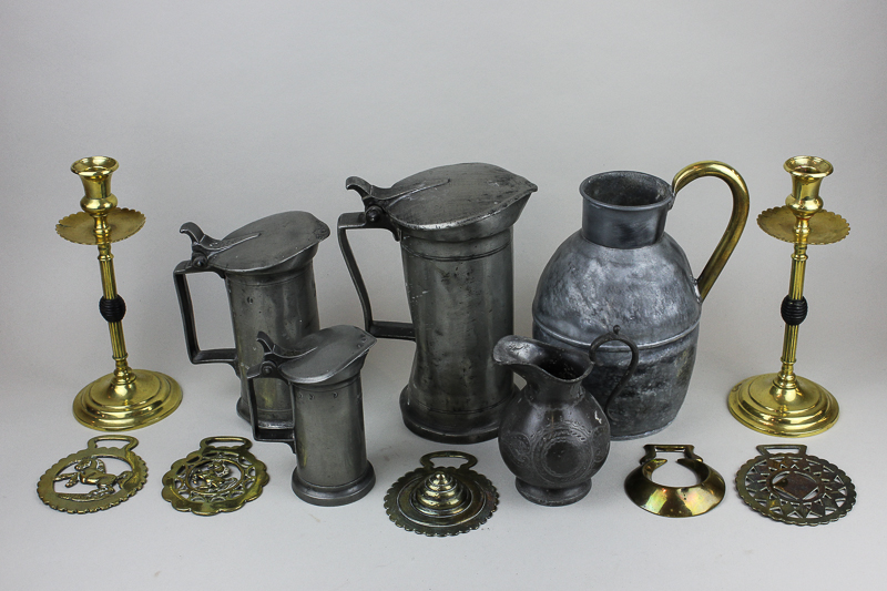 Three 19th century graduated Swiss pewter measures with hinged lids and thumb pieces, tallest 21cm;