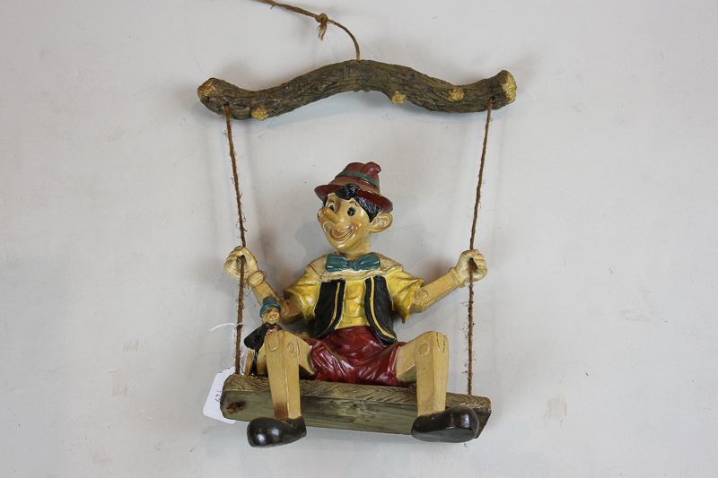 A figure of Pinocchio on a swing, 25cm high